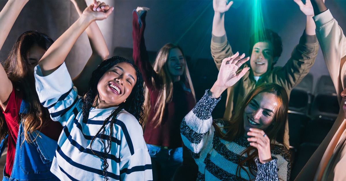 People dancing energetically at a lively party, enjoying the night.