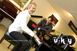 Two men enjoying a piano session at a music studio with Funkeys logo.